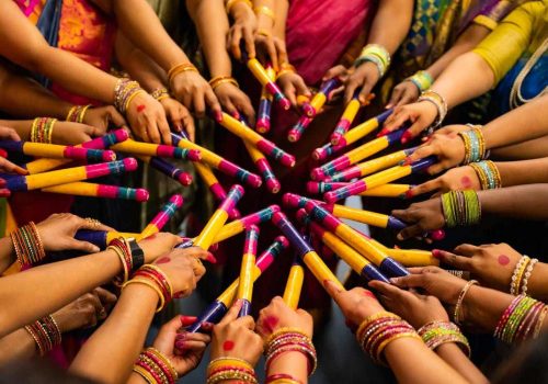 women playing dandiya